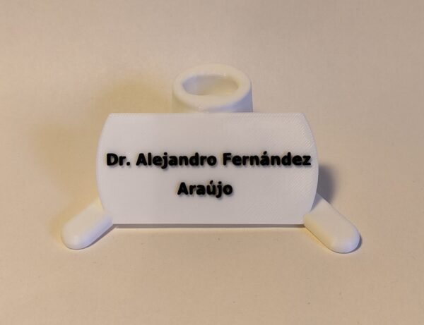 Primer plano de la base de un modelo anatómico con la inscripción grabada "Futuro Cirujano" o una cita inspiradora, sosteniendo el modelo.